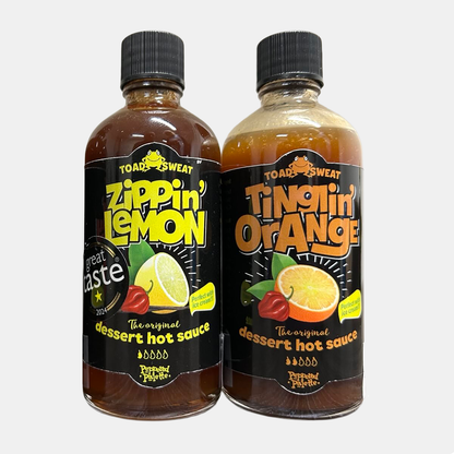 Two bottles of dessert hot sauce, one labeled 'Zippin Lemon' and the other 'Tinglin Orange', on a white background.